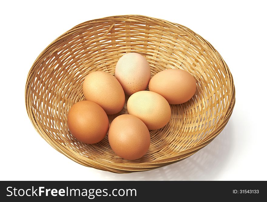 Brown eggs on a wicker basket.