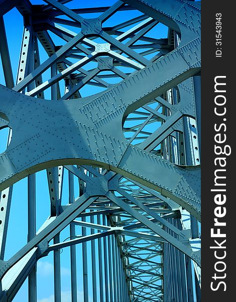 Close-up of steel bridge against blue sky. Close-up of steel bridge against blue sky