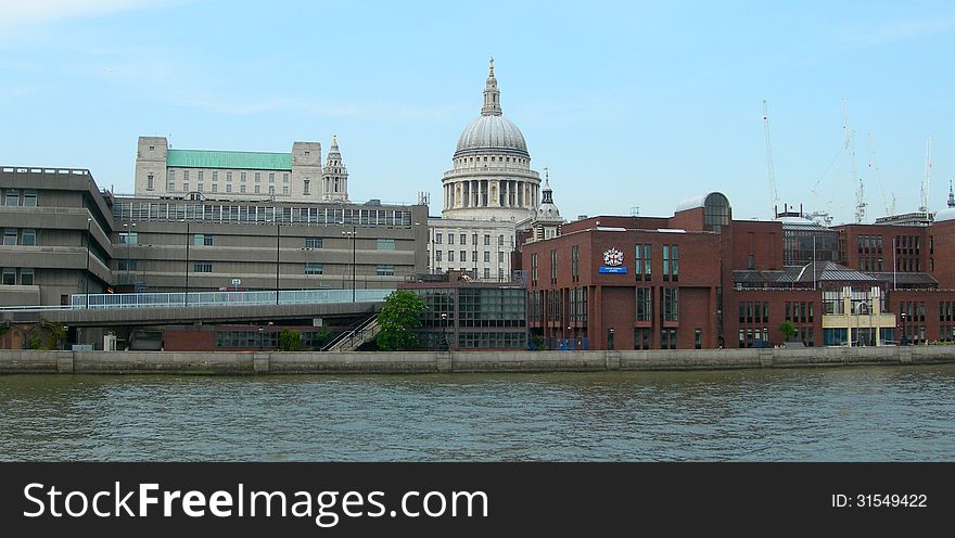 Modern and classic architecture with St Pauls cathedral as background, along the river Thames in London, UK. Modern and classic architecture with St Pauls cathedral as background, along the river Thames in London, UK