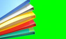 Stack Of Colorful Folders On A Green Background Stock Images