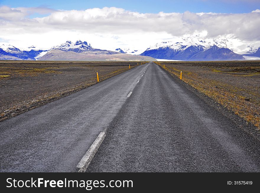 Icelandic road and mountains on horizon. Icelandic road and mountains on horizon