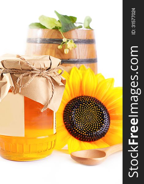 Jar and barrel with honey and flowers