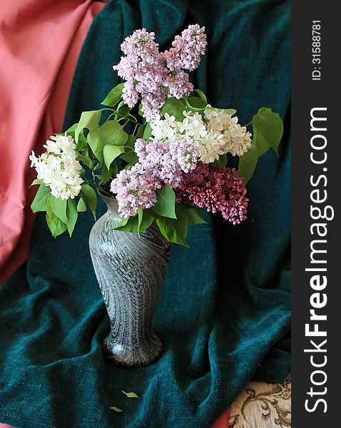 The posy of colorful lilac in the vase. The posy of colorful lilac in the vase