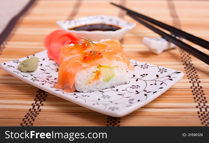 Japanese food - sushi with salmon and red caviar on a wicker napkin