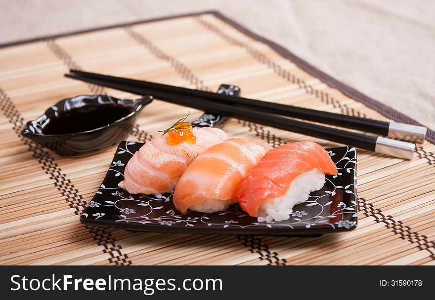 Mix sushi with salmon, smoked, fried. Japanese table setting. Mix sushi with salmon, smoked, fried. Japanese table setting