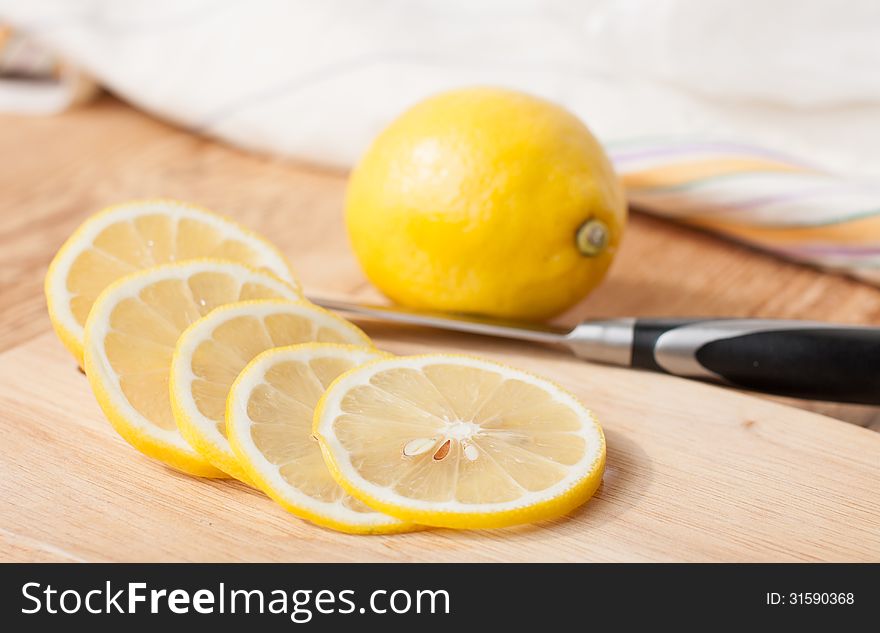 Sliced ​​lemon for dessert on the kitchen blackboard. Sliced ​​lemon for dessert on the kitchen blackboard