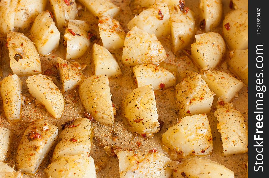 Sliced â€‹â€‹potatoes with spices, to bake