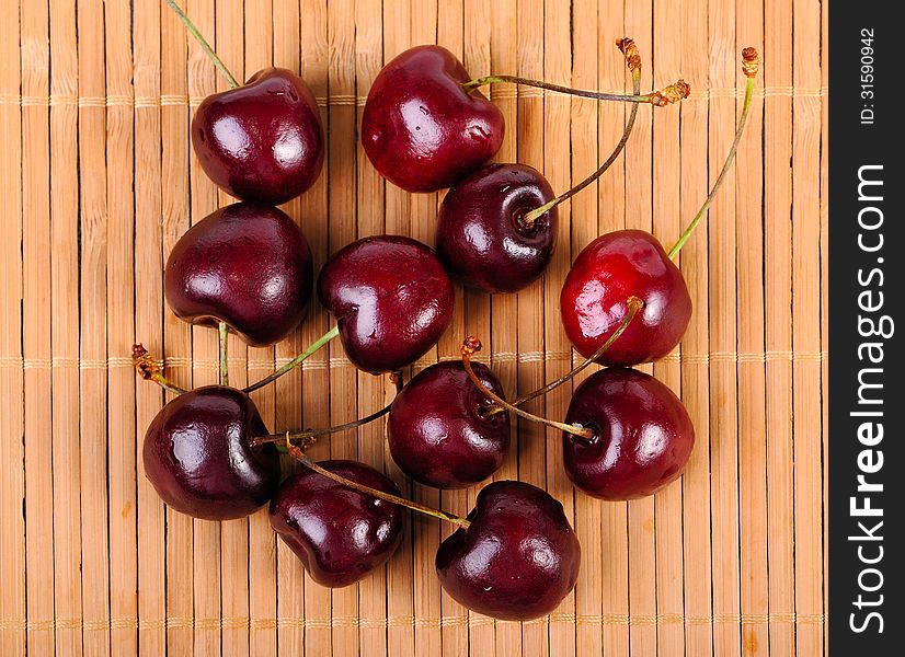 Heap of sweet cherries in water drops on a mat