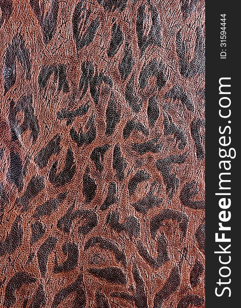 Brown leather background with a darker brown design