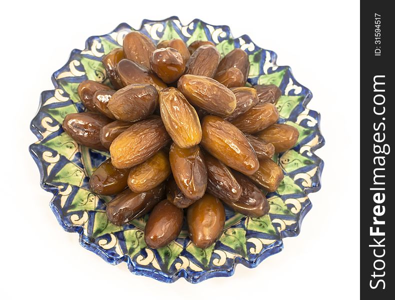 Dried figs in the Central Asian ceramic saucer isolated on white background