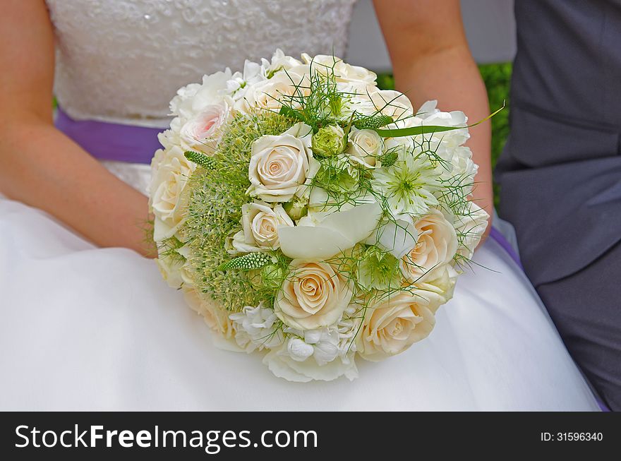 Bride holding wedding bouquet in her hands