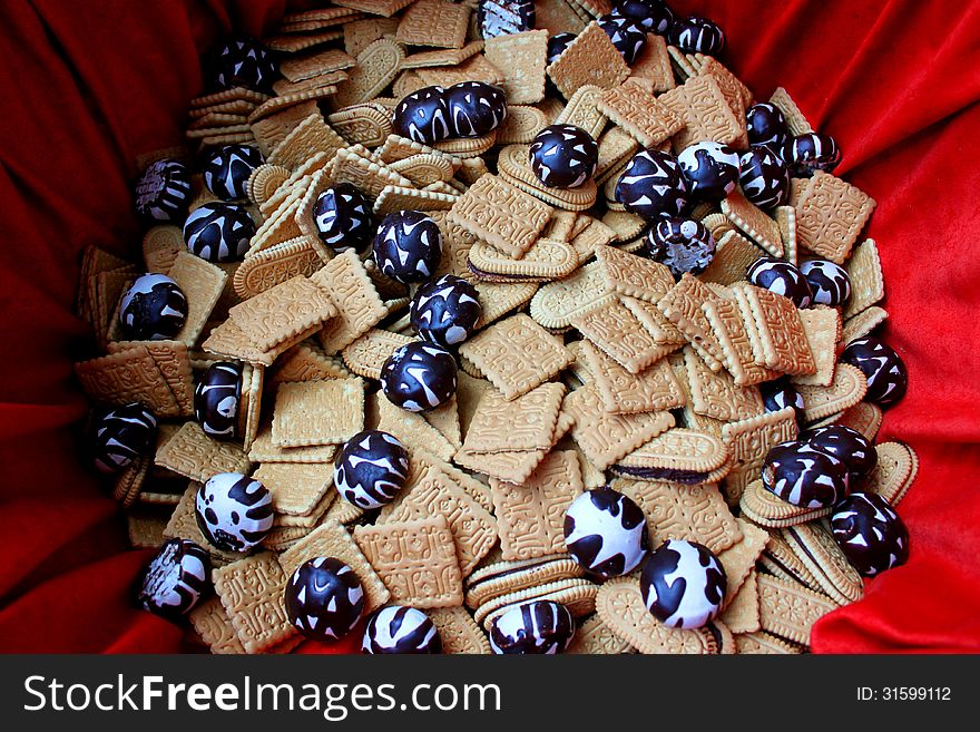 Gingerbread and biscuits on red background