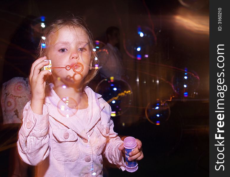 Little girl blow soap bubbles