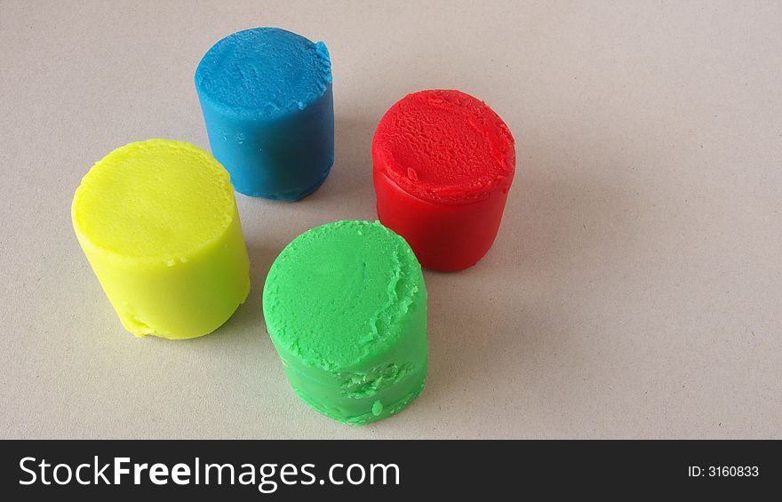 Four peaces of plasticine in neon colours