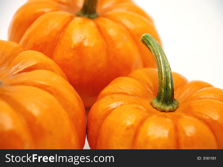 Pumpkins over white background