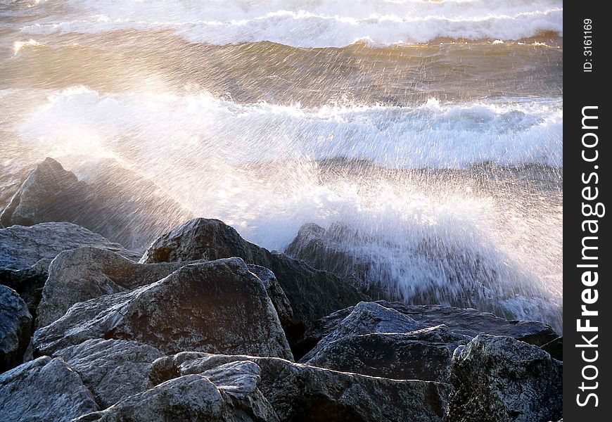 Wild waves crashing on rocks. Wild waves crashing on rocks.