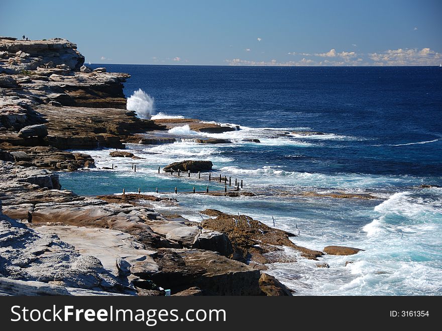 Ocean pool by coast with blue sky