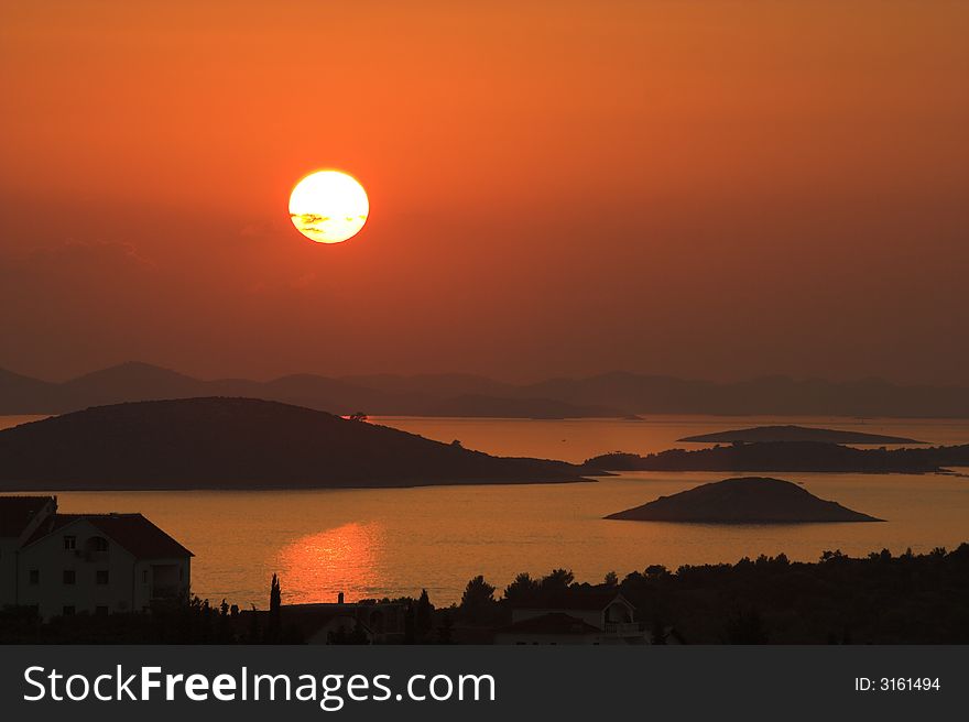 Perfect day. Sunset over island.