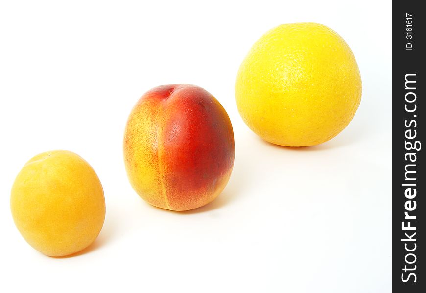 Three fruits apricot nectarine and orange in line on white background. Three fruits apricot nectarine and orange in line on white background