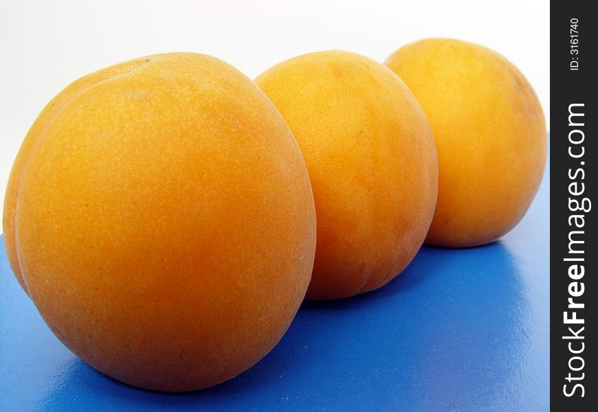 Three Apricots On Table