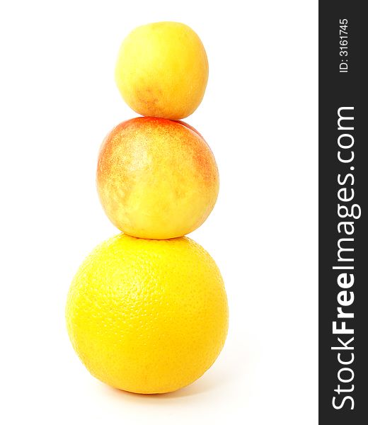 Isolated tower made from fruits: apricot, nectarine and orange. Isolated tower made from fruits: apricot, nectarine and orange