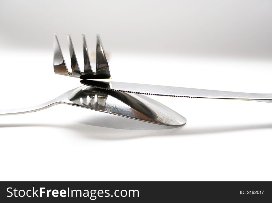 Spoon, knife and fork on white