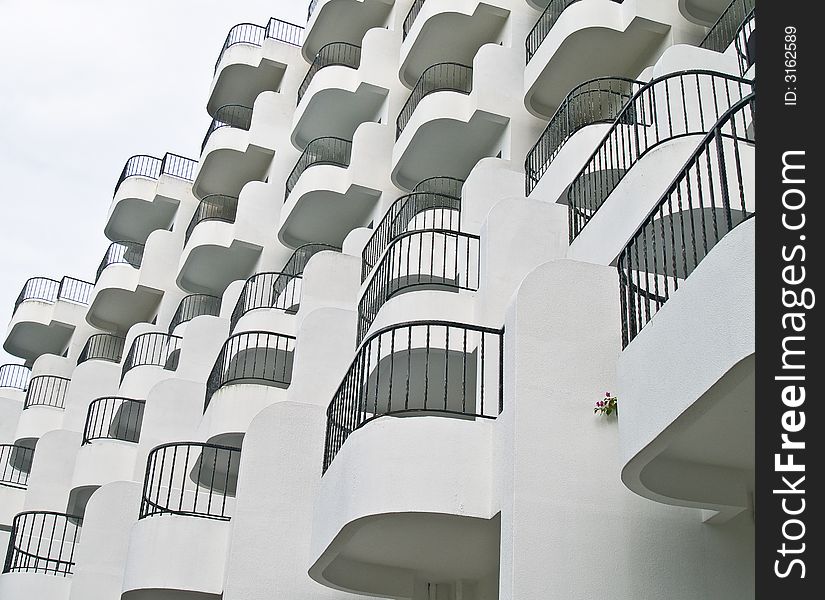 White balconies of a multi storey hotel in a tropical island resort. White balconies of a multi storey hotel in a tropical island resort