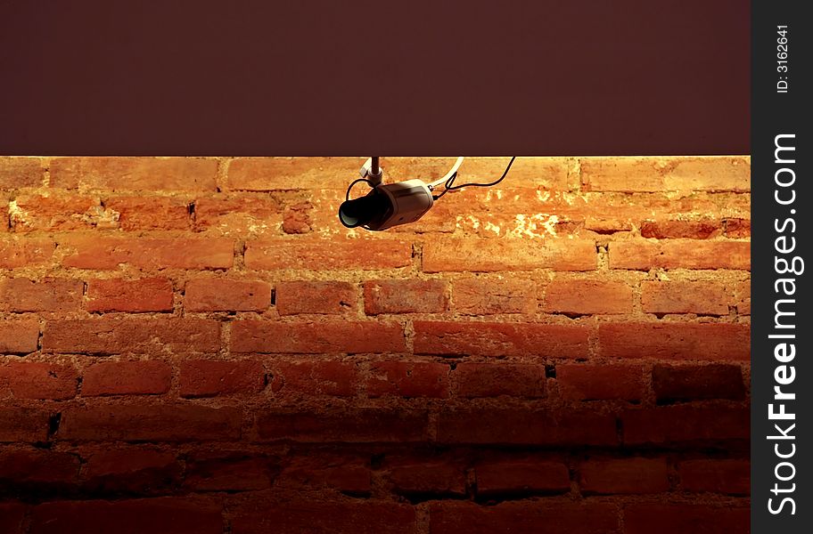 Surveillance system on the brick wall background