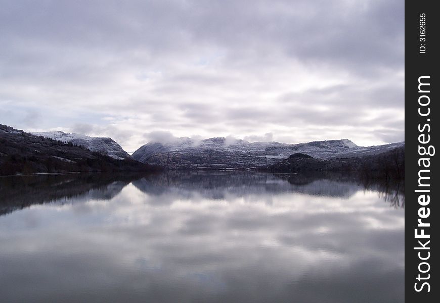 Cloudy landscape on a Lake that reflects it. Cloudy landscape on a Lake that reflects it