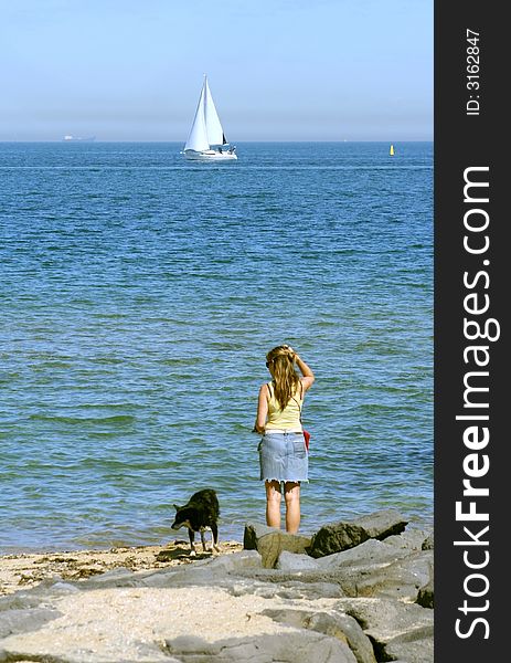 Woman and dog at St Kilda beach, Melbourne, Australia. Woman and dog at St Kilda beach, Melbourne, Australia