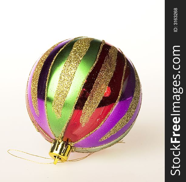 Fur-tree toy: A sphere covered by multi-coloured strips and a gold dust. Fur-tree toy: A sphere covered by multi-coloured strips and a gold dust
