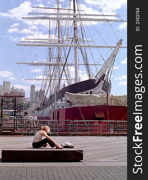 A student reads a newspaper on the New York waterfront during lunch break in the Manhattan financial district. A student reads a newspaper on the New York waterfront during lunch break in the Manhattan financial district.