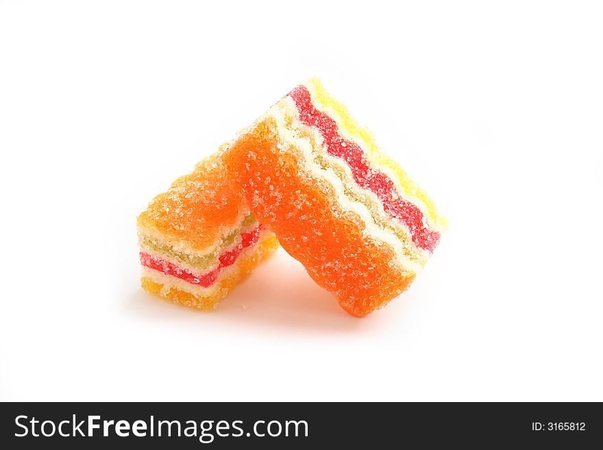 On a photo a piece of multi-coloured fruit candy