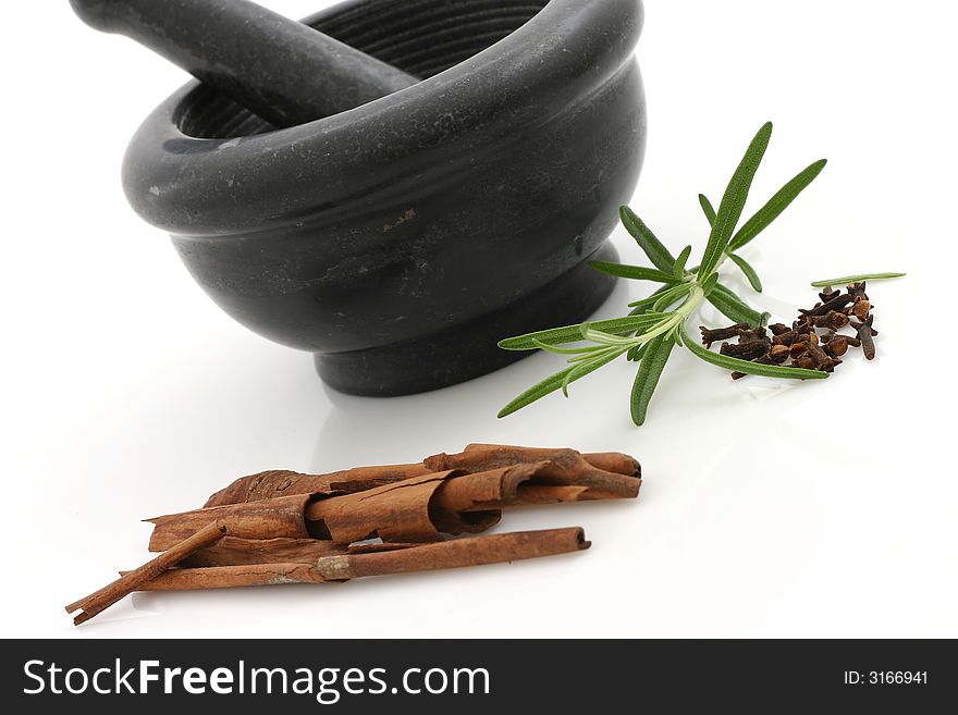 Seasonings and stone mortar (cinnamon, rosemary)