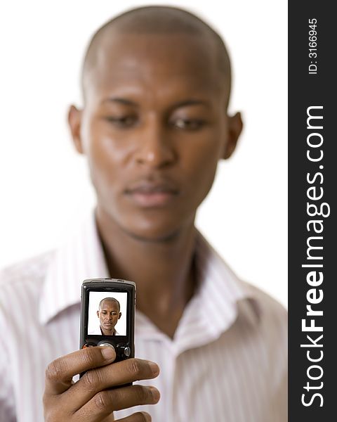 This is an image of businessman taking a self portrait with his cellphone. This is an image of businessman taking a self portrait with his cellphone