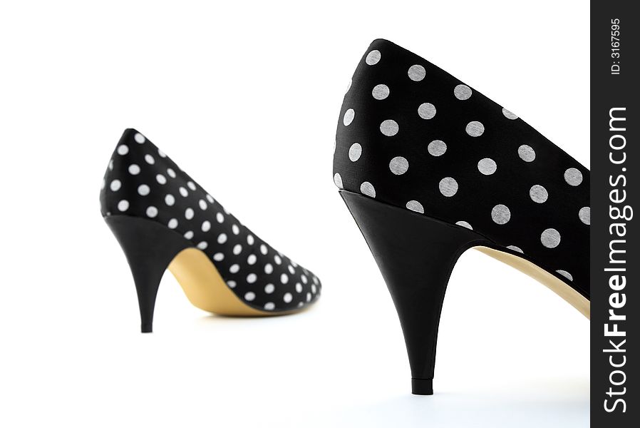 Black polka high heel shoes. Focus on the closest shoe.