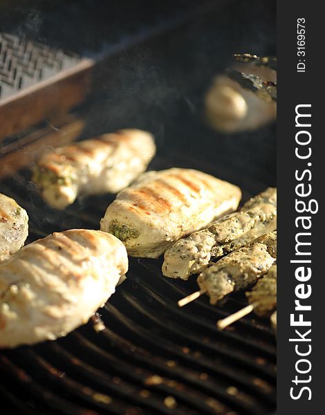 Chicken and skewered pork grilling on bbq. Chicken and skewered pork grilling on bbq