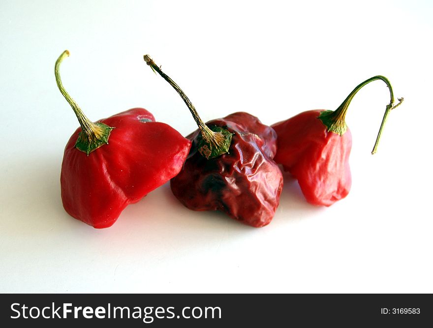 Red hot chilli peppers isolated on white background - dried out. Red hot chilli peppers isolated on white background - dried out.