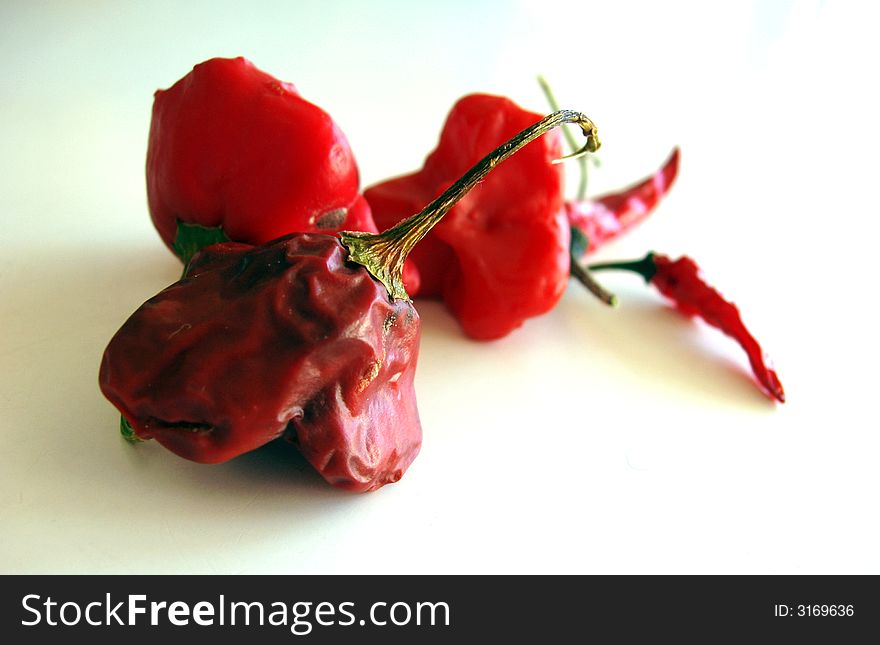 Red hot chilli peppers isolated on white background - dried out. Red hot chilli peppers isolated on white background - dried out.