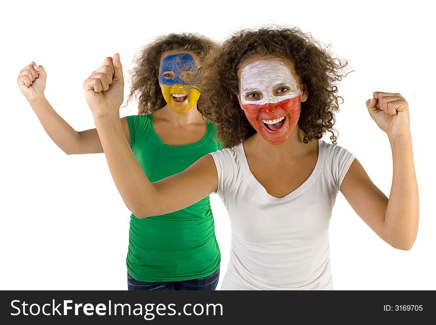 Happy female fans with painted Polish and Slovakian flags on faces. They're looking at camera. Focus on first person. They're on white background. Front view. Happy female fans with painted Polish and Slovakian flags on faces. They're looking at camera. Focus on first person. They're on white background. Front view.