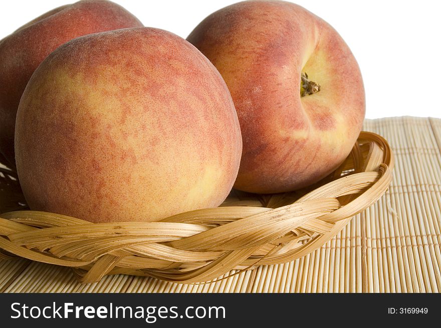 Peaches in pan on place mat isolated