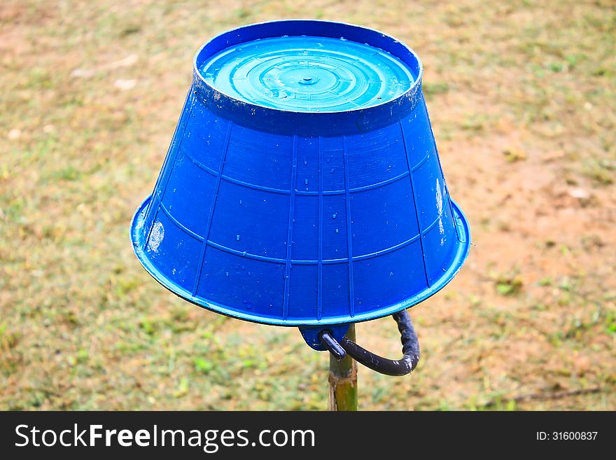 Blue water bucket inverted in the garden. Blue water bucket inverted in the garden
