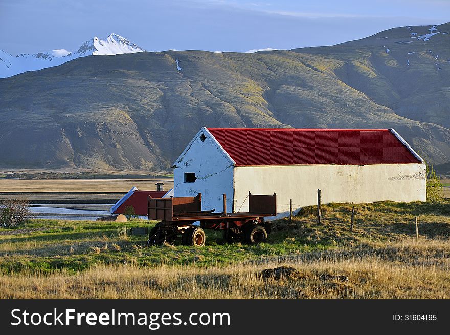 Farm with a red roof in Iceland on sunset. Farm with a red roof in Iceland on sunset