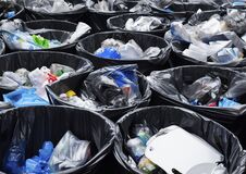 A Lot Of Black Bins Filled With Garbage. Stock Image