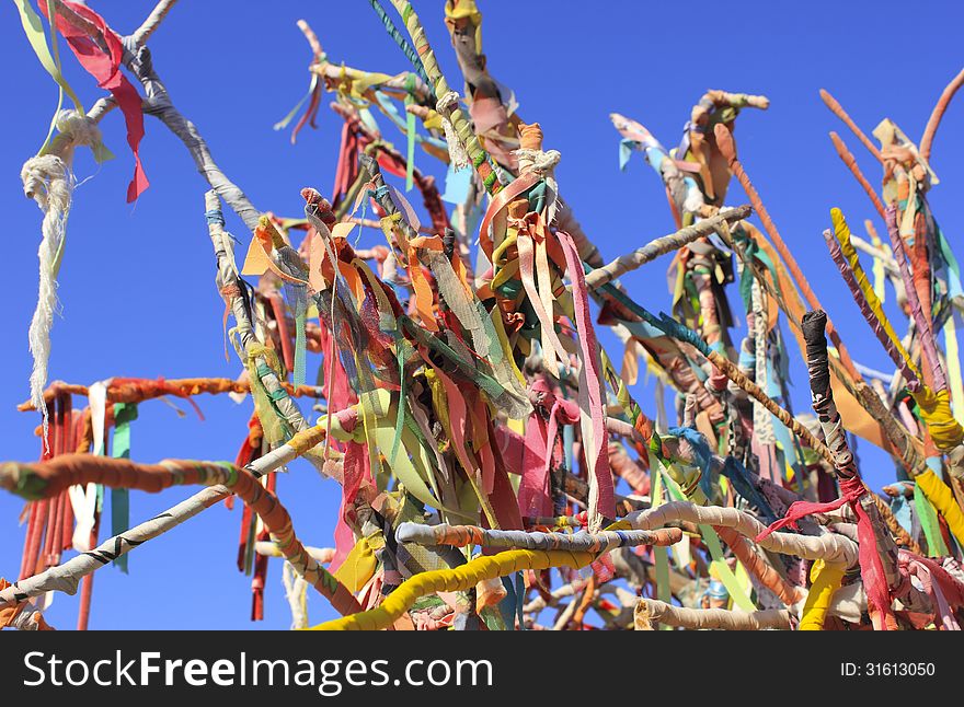 Colorful ribbons and scraps on wishes tree. Colorful ribbons and scraps on wishes tree