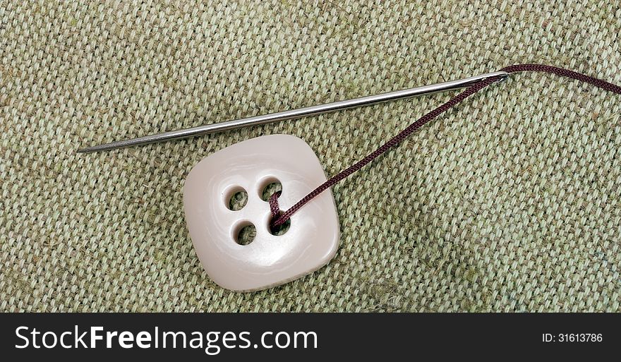 Sewing needle and thread with buttons