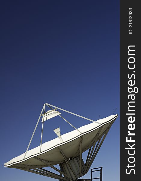 Photo of a Satellite Dish with a blue sky in background. Photo of a Satellite Dish with a blue sky in background