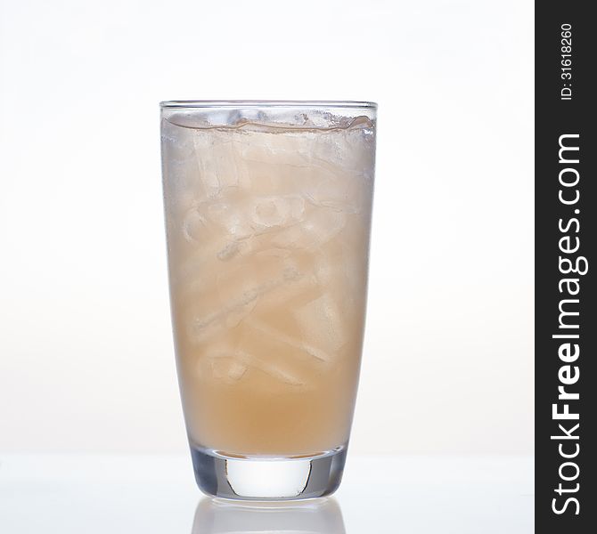 Fresh and cold tamarind fruit juice in glass on white background