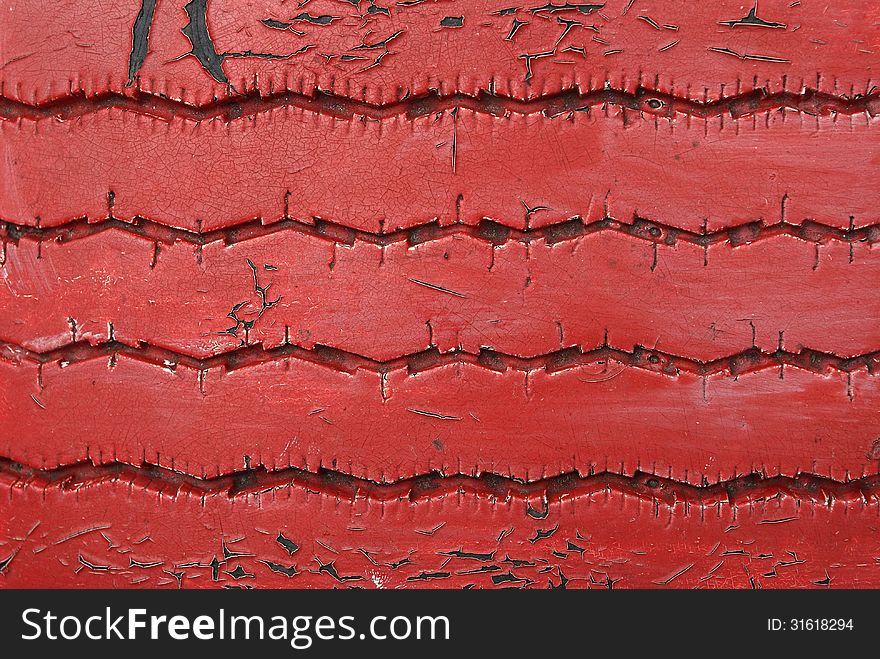 Detail of grunge and cracked red tire texture