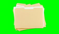 A Stack Of  Folders With Blank Labels On A Green Background. Chroma Key. Royalty Free Stock Photos